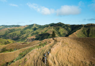Hiking group through Fiji Highlands via a drone