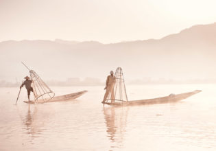First light hits Inle Lake and the cone-fishermen start their working day.