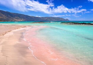 The pink sand at and turquoise water at Elafonissi Beach, Crete, Greece.