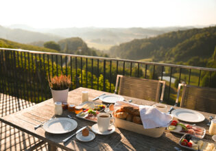 A traditional Austrian meal, beautifully presented on a table with breathtaking views beyond.