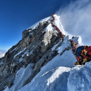 People queuing to reach Mount Everest Summit/Top of the World / Highest Mountain in the Himalayas Nepal