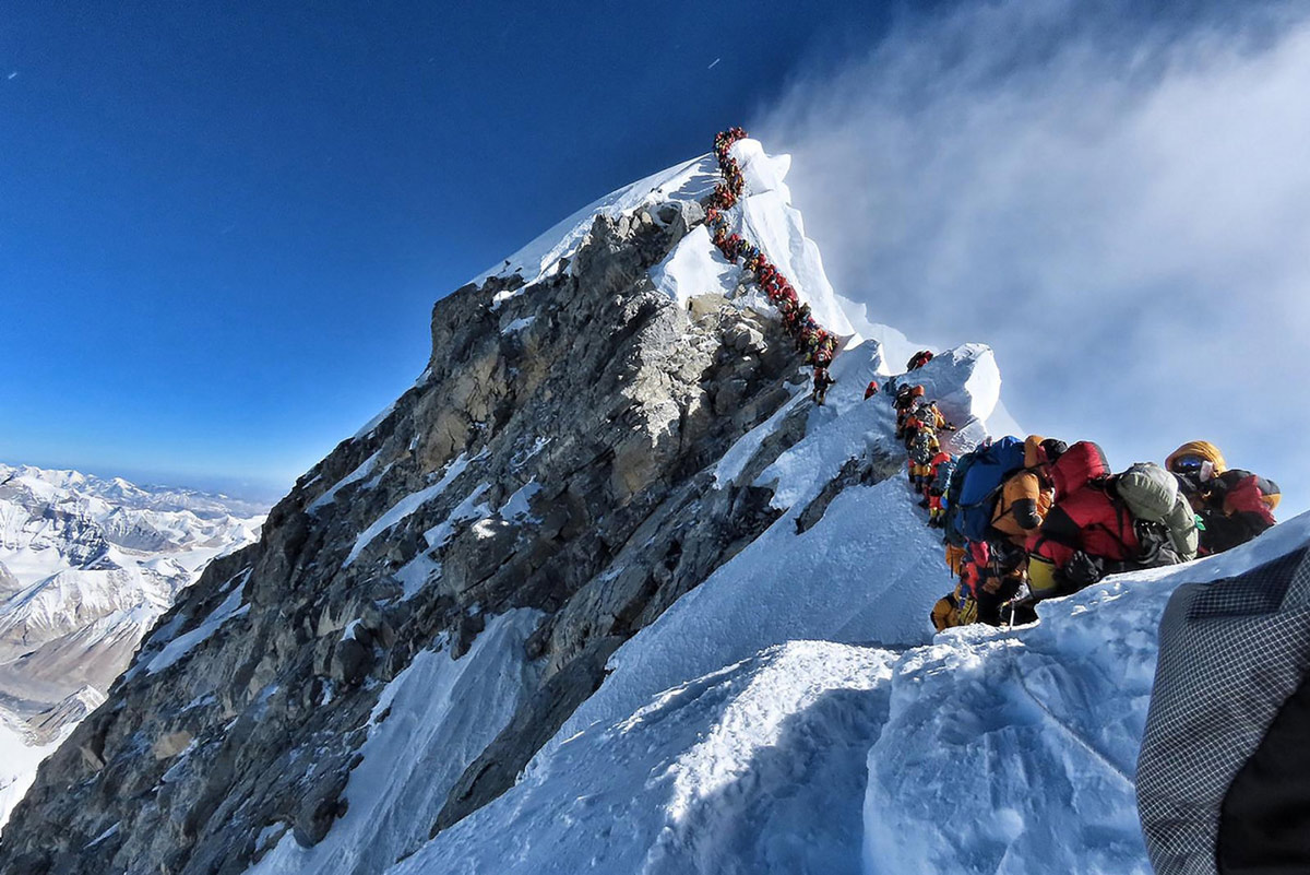 People queuing to reach Mount Everest Summit/Top of the World / Highest Mountain in the Himalayas Nepal
