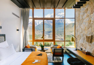 floor-to-ceiling windows frame views of the snow-capped Nilgiri Himal peaks at Shinta Mani Mustang