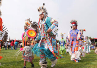tribal dancers in colourful costumes at United Tribes Technical College (UTTC) International Powwow