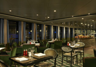 the dimly lit dining setting of Moderno Churrascaria, NCL Norwegian Dawn
