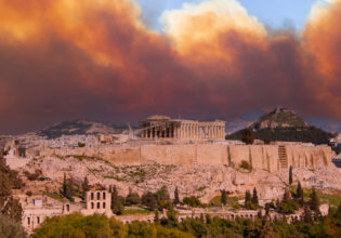 View of the Acropolis and the Parthenon against the background of smoke from fires in Athens
