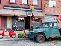 a woman sitting outside Sunny's Bar, Red Hook, NYC