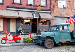 a woman sitting outside Sunny's Bar, Red Hook, NYC