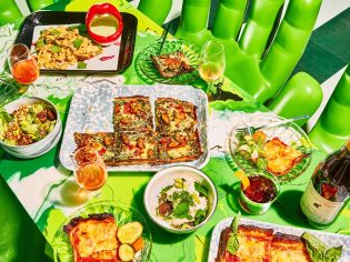 a wide selection of dishes on the green table at Shuggie’s Trash Pie and Natural Wine Bar