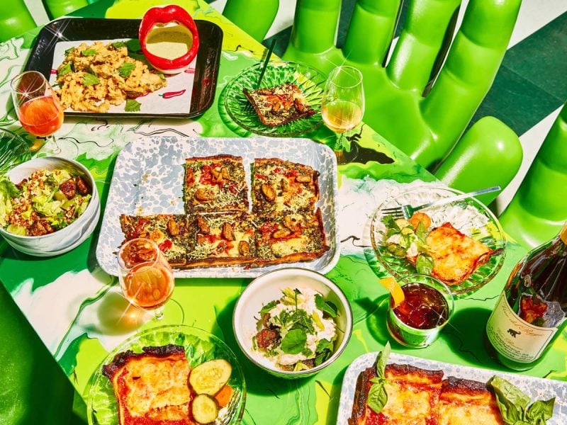 a wide selection of dishes on the green table at Shuggie’s Trash Pie and Natural Wine Bar