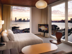 Corner rooms feature floor-to-ceiling, wall-to-wall windows that open.