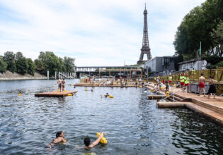 People swimming in the River Seine with a view of the Eiffel Tower