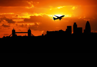 Jumbo jet flying over the London skyline.