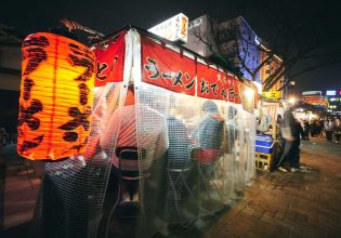 customers dining behind the curtains inside a Yatai food stall along Fukuoka